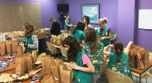 Girl Scout Troop 16123 members pack Mother’s Day bags at CROSS as part of their Bronze Award project.  (Photo provided by Teresa Lutz)